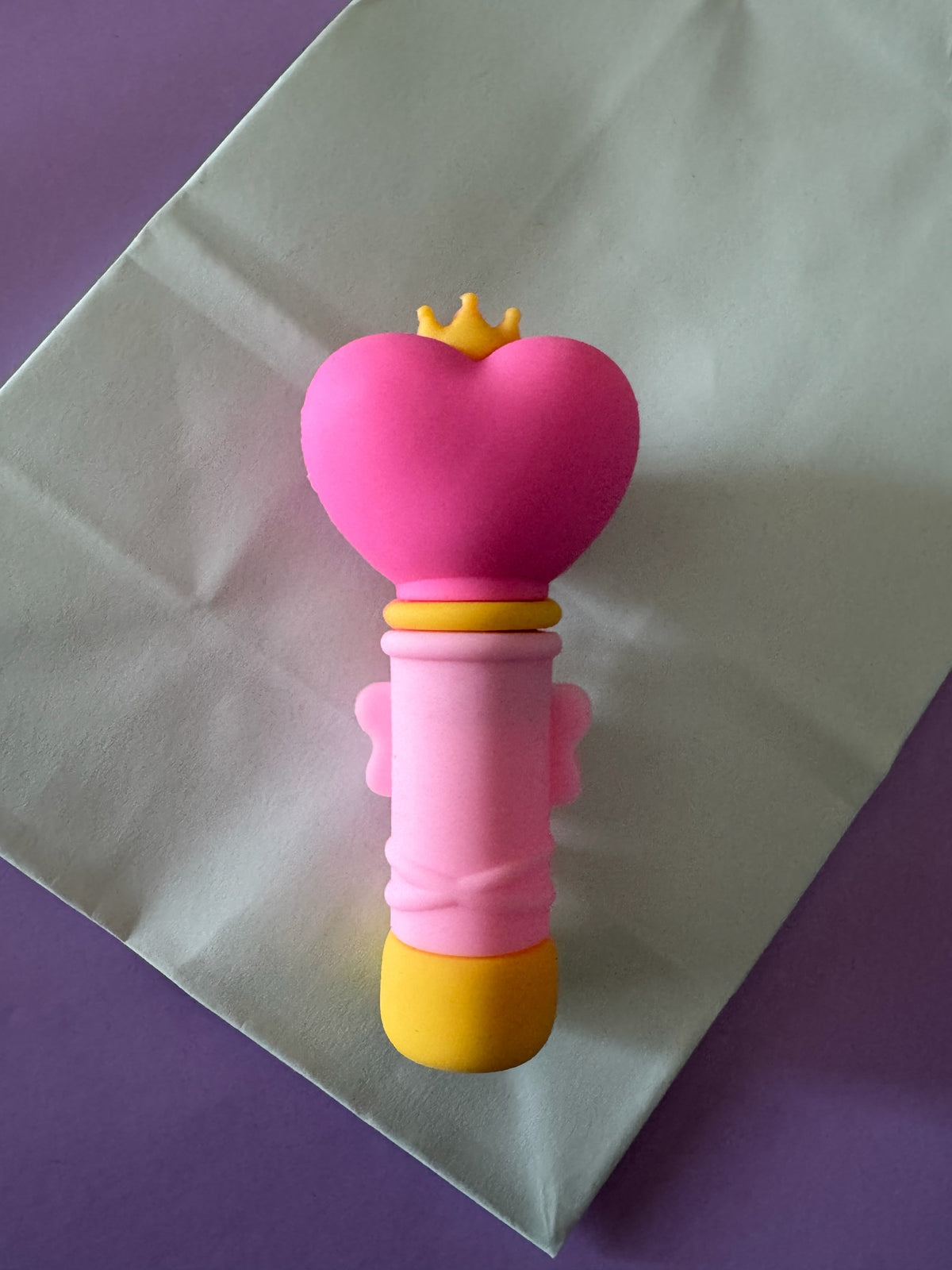 Atomizador de perfume Brena con diseño de varita mágica en colores rosa, amarillo y azul con detalle de corona.