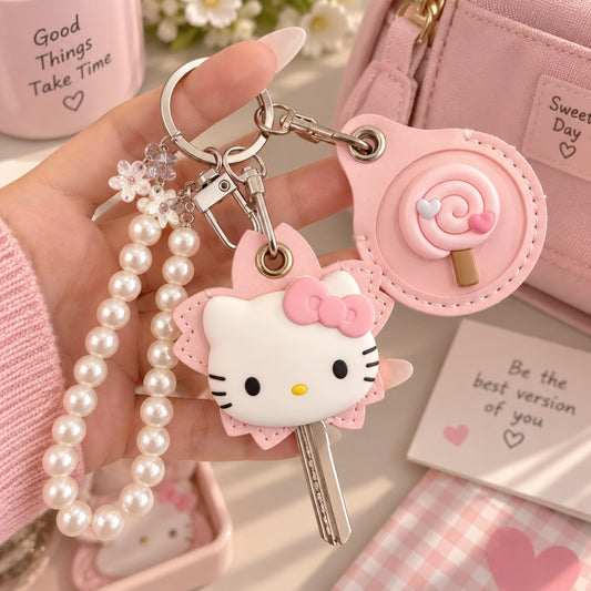 Llavero Brena de Hello Kitty en color rosa con correa de perlas sintéticas y dije de paleta dulce