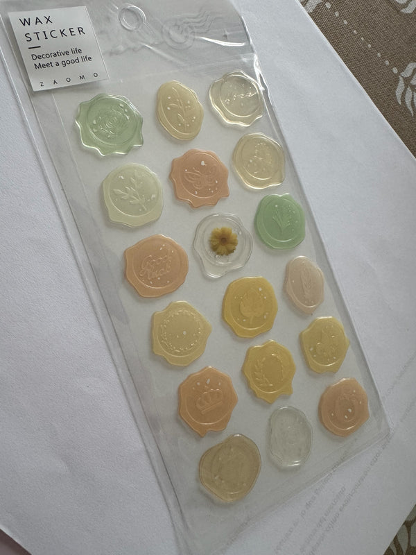 Set de stickers Brena con diseño de sello de cera en tonos pastel, verde y dorado, con motivos botánicos y vintage.